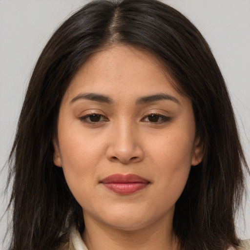 Joyful asian young-adult female with long  brown hair and brown eyes