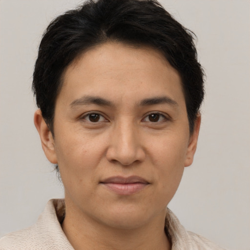 Joyful latino adult female with short  brown hair and brown eyes