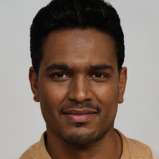 Joyful black young-adult male with short  black hair and brown eyes