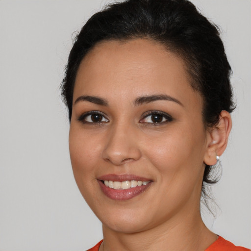 Joyful latino young-adult female with short  brown hair and brown eyes