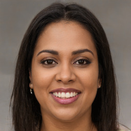 Joyful latino young-adult female with long  brown hair and brown eyes