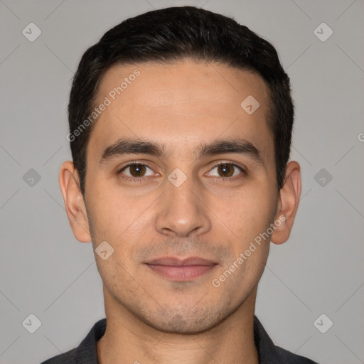 Joyful white young-adult male with short  black hair and brown eyes