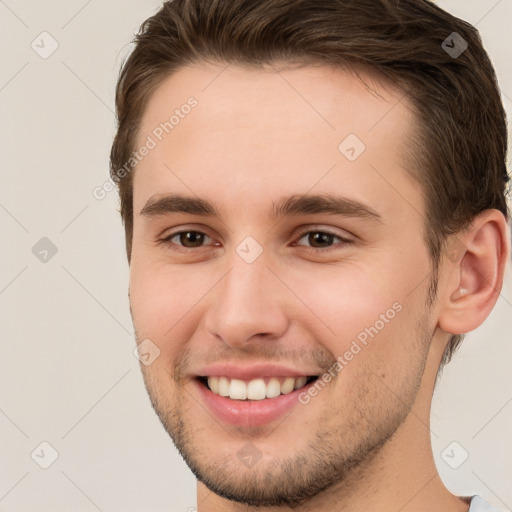 Joyful white young-adult male with short  brown hair and brown eyes