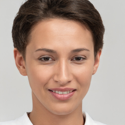 Joyful white young-adult female with short  brown hair and brown eyes