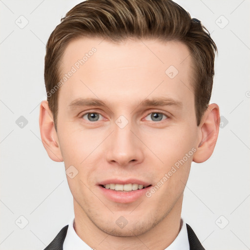 Joyful white young-adult male with short  brown hair and grey eyes