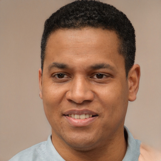 Joyful latino young-adult male with short  black hair and brown eyes