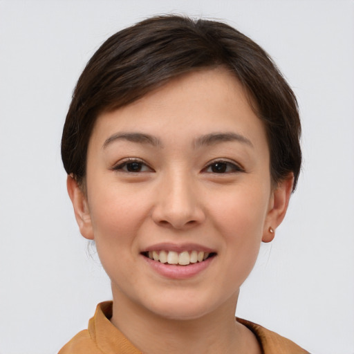 Joyful asian young-adult female with short  brown hair and brown eyes