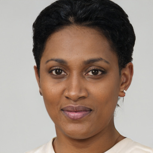 Joyful latino young-adult female with short  black hair and brown eyes