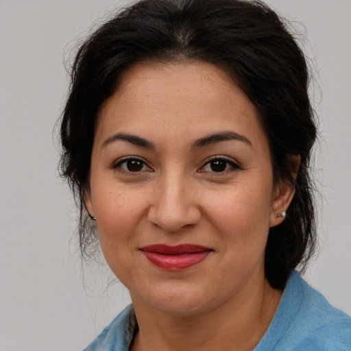 Joyful asian adult female with medium  brown hair and brown eyes