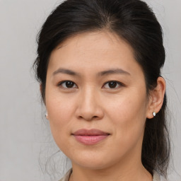 Joyful asian young-adult female with medium  brown hair and brown eyes