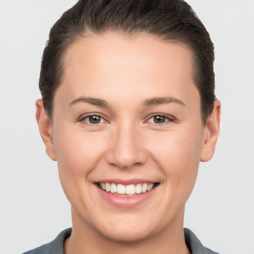 Joyful white young-adult female with short  brown hair and brown eyes