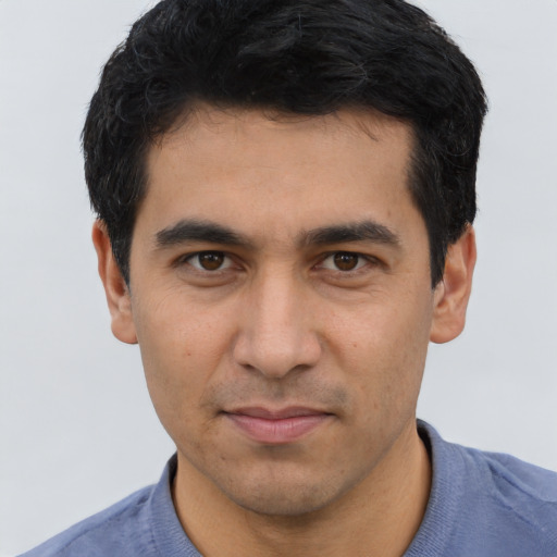 Joyful asian young-adult male with short  black hair and brown eyes