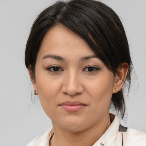 Joyful asian adult female with medium  brown hair and brown eyes
