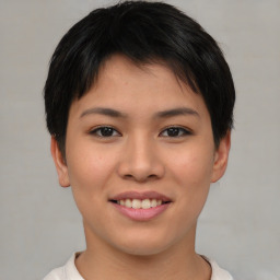 Joyful asian young-adult female with short  brown hair and brown eyes