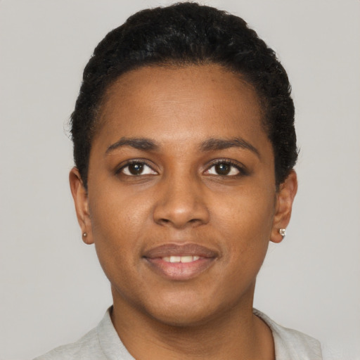 Joyful black young-adult female with short  black hair and brown eyes