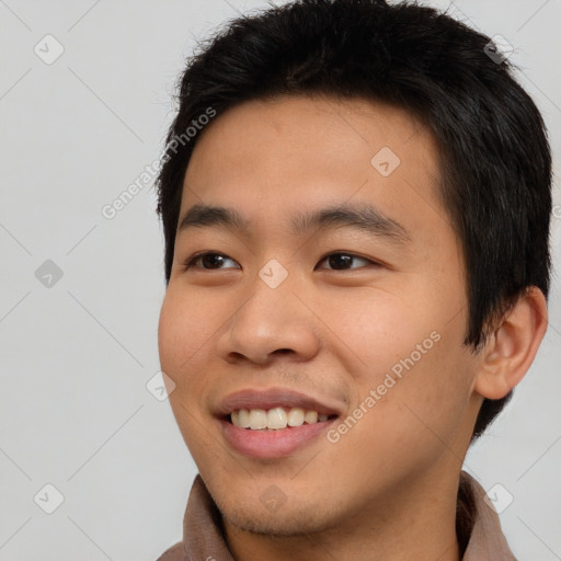 Joyful asian young-adult male with short  black hair and brown eyes