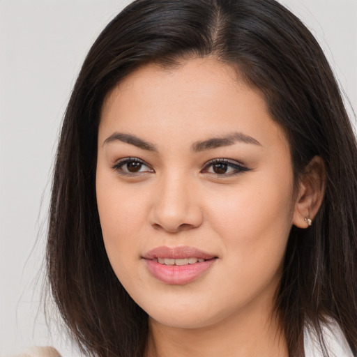 Joyful asian young-adult female with long  brown hair and brown eyes