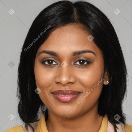 Joyful black young-adult female with long  black hair and brown eyes