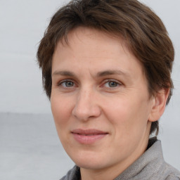 Joyful white adult female with short  brown hair and brown eyes