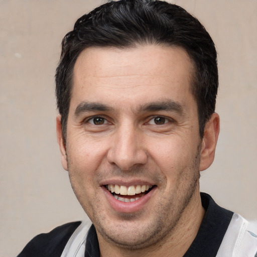 Joyful white adult male with short  brown hair and brown eyes