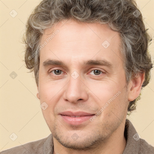 Joyful white adult male with short  brown hair and grey eyes