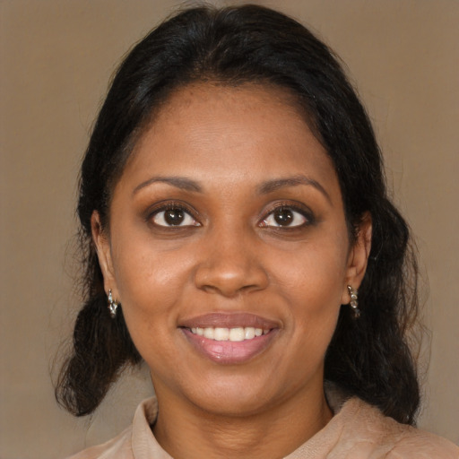 Joyful black young-adult female with medium  brown hair and brown eyes