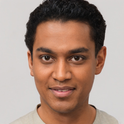 Joyful black young-adult male with short  black hair and brown eyes