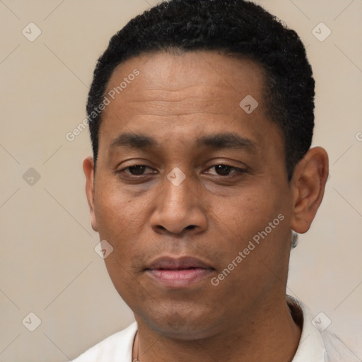 Joyful latino adult male with short  black hair and brown eyes