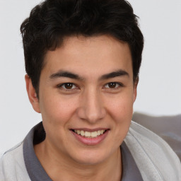 Joyful latino young-adult male with short  brown hair and brown eyes