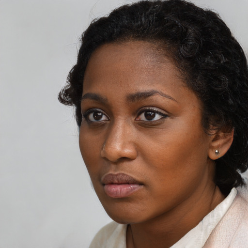 Neutral black young-adult female with short  brown hair and brown eyes