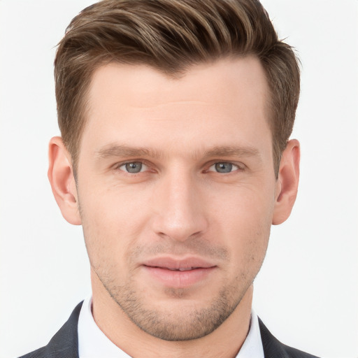 Joyful white young-adult male with short  brown hair and grey eyes