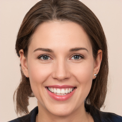 Joyful white young-adult female with medium  brown hair and brown eyes