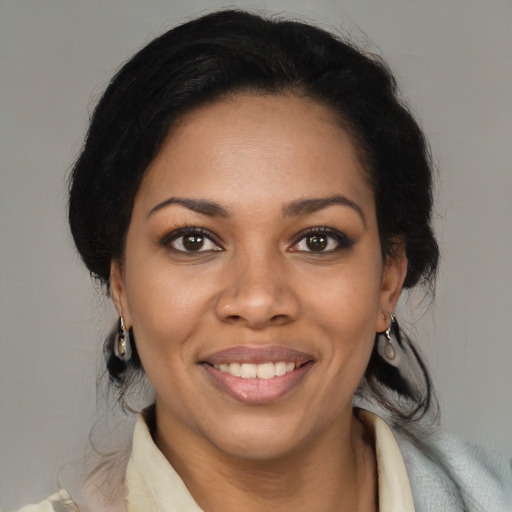 Joyful black young-adult female with medium  brown hair and brown eyes