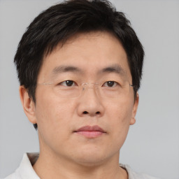 Neutral asian adult male with short  brown hair and brown eyes