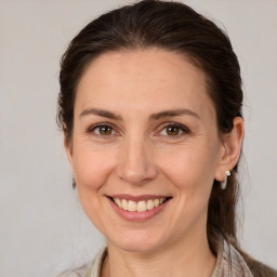 Joyful white adult female with medium  brown hair and brown eyes