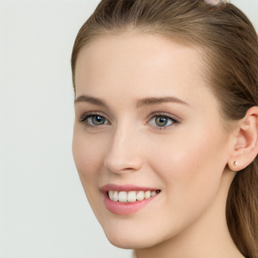 Joyful white young-adult female with long  brown hair and grey eyes