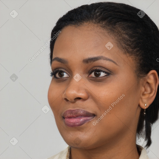 Joyful black young-adult female with medium  black hair and brown eyes