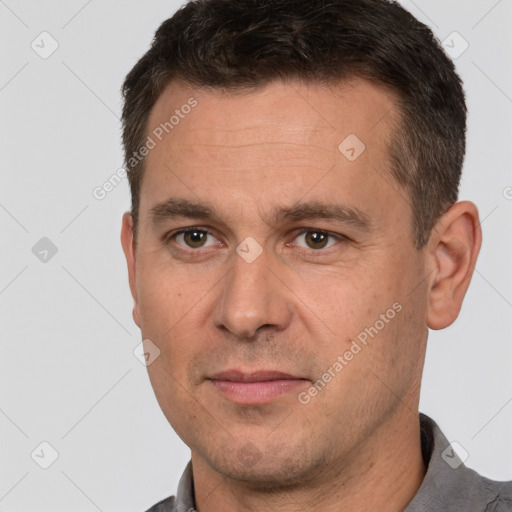 Joyful white adult male with short  brown hair and brown eyes