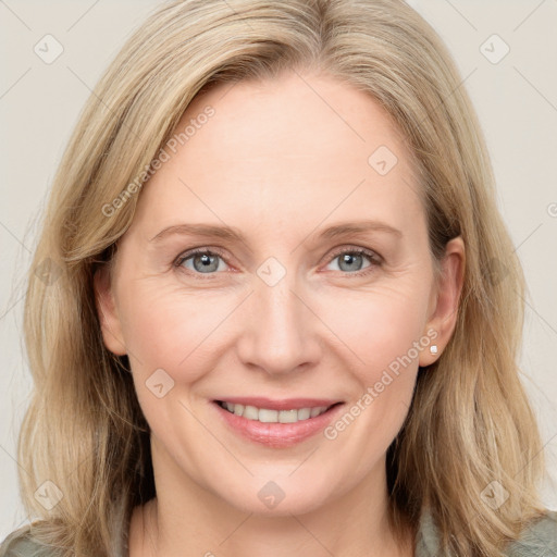 Joyful white young-adult female with long  brown hair and blue eyes