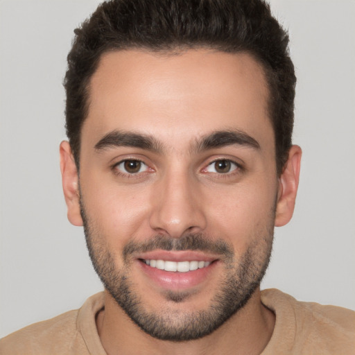 Joyful white young-adult male with short  brown hair and brown eyes