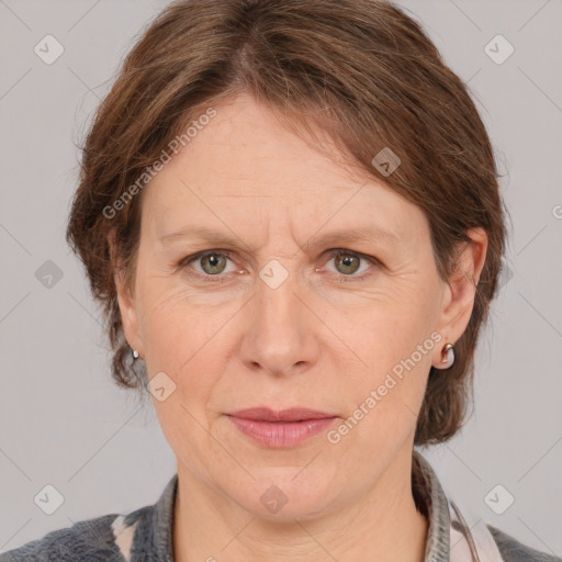 Joyful white adult female with medium  brown hair and grey eyes