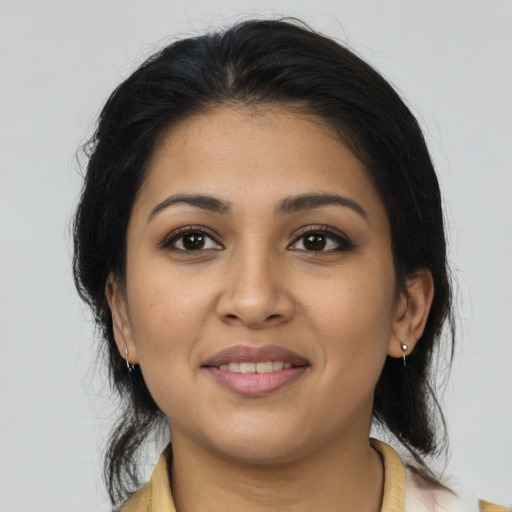Joyful latino young-adult female with medium  brown hair and brown eyes