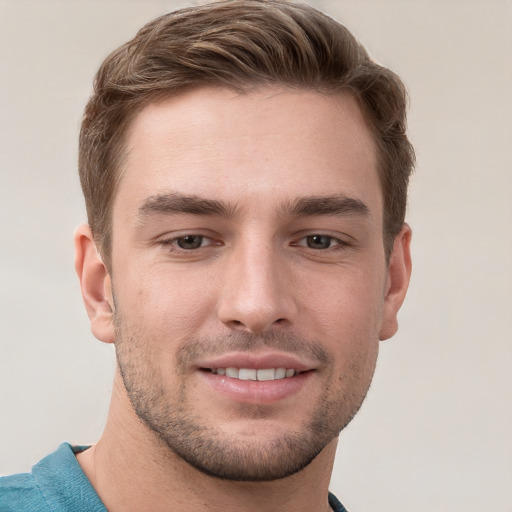 Joyful white young-adult male with short  brown hair and grey eyes