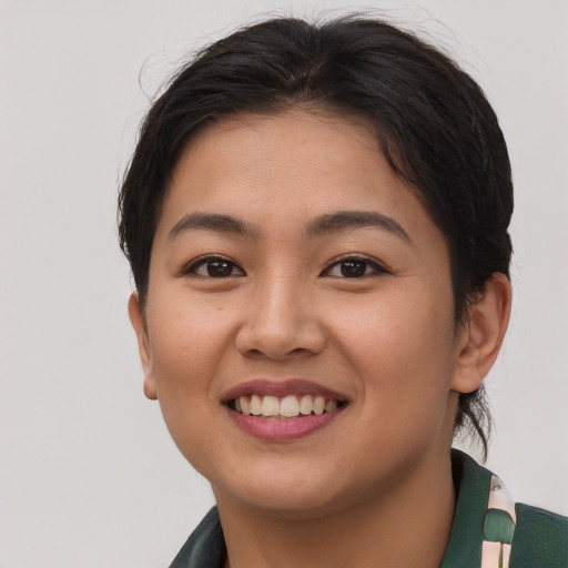 Joyful asian young-adult female with short  brown hair and brown eyes