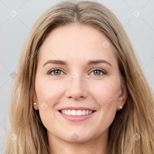 Joyful white young-adult female with long  brown hair and grey eyes