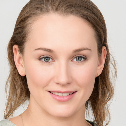 Joyful white young-adult female with medium  brown hair and blue eyes