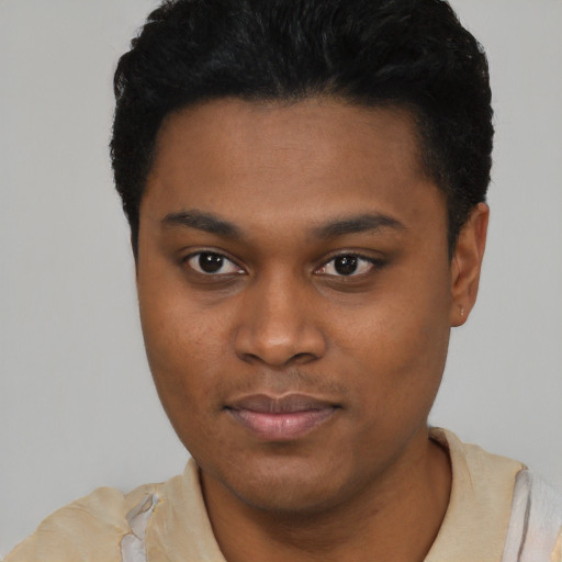 Joyful black young-adult male with short  black hair and brown eyes