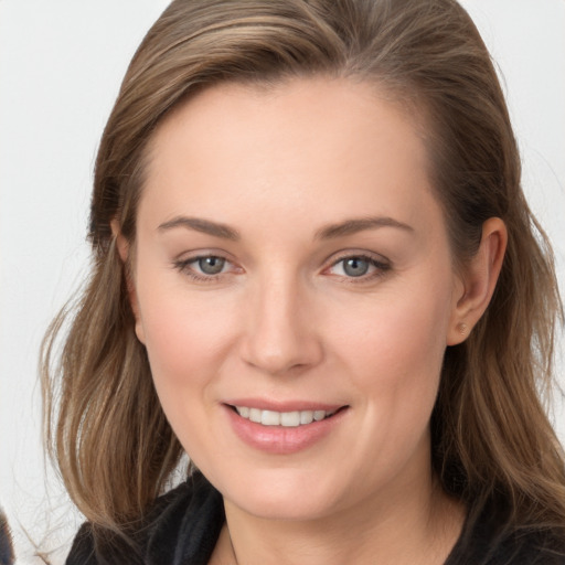 Joyful white young-adult female with long  brown hair and grey eyes