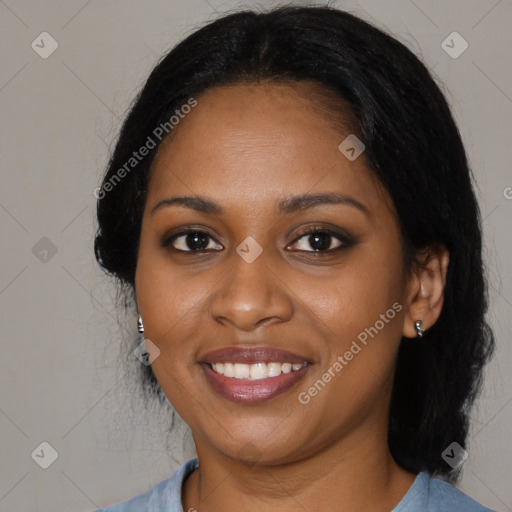 Joyful black young-adult female with long  black hair and brown eyes