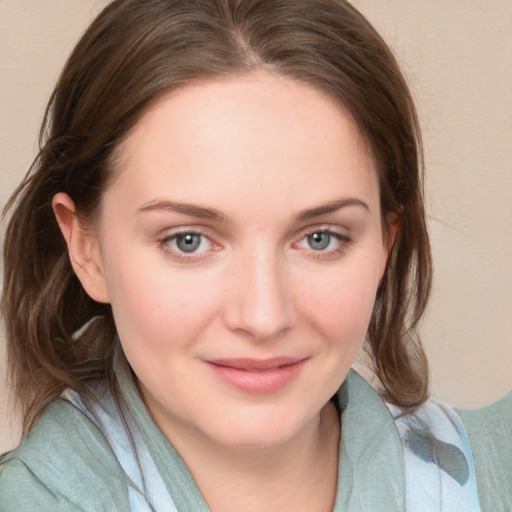 Joyful white young-adult female with medium  brown hair and blue eyes